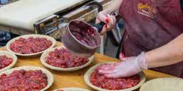 Baugher’s Dottie Baugher Dunn and Sharon Kinser prepare cherry pies.