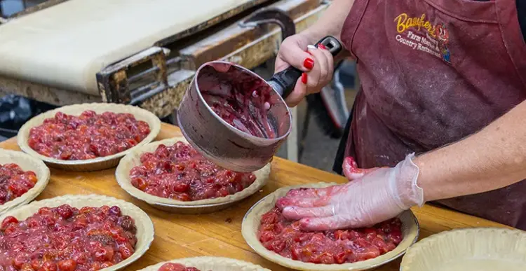 Baugher’s Dottie Baugher Dunn and Sharon Kinser prepare cherry pies.