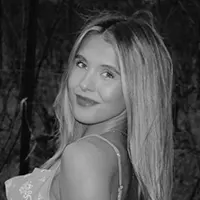 AlinaAyoubAuthorHeadshotOne - Carroll News | Carroll Publications | Carroll County, MD - Carroll News | Carroll Publications | Carroll County, MD Black-and-white portrait of a smiling woman with shoulder-length hair outdoors, looking at the camera.