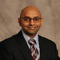 LeonardArvi_potm - Carroll News | Carroll Publications | Carroll County, MD - Carroll News | Carroll Publications | Carroll County, MD Professional headshot of a bald man in a dark suit, white shirt, and striped tie, wearing glasses and a subtle smile against a neutral backdrop.