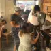 McDaniel Cinema Showcase 2026_Featured Image - Carroll News | Carroll Publications | Carroll County, MD Group of people filming a video in a cafe, with a camera on a tripod and a monitor setup in the center of the scene.