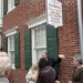 hscc-opening-feature-image - Carroll News | Carroll Publications | Carroll County, MD Crowd gathers outside a brick historic library building with green shutters and a hanging sign for Cockey's Helen B. Gorman Library of Carroll County History.
