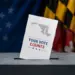 Ballot being dropped into a ballot box with a 'Your Vote Counts' card, patriotic flags in the background.