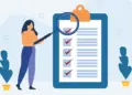 Person standing beside a large clipboard with a checklist and a magnifying glass zooming in on items to review the list for accuracy.