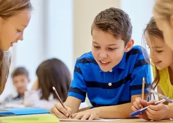 carroll-news-ccps-image - Carroll News | Carroll Publications | Carroll County, MD Group of four kids sit at a table, writing and drawing together in a bright classroom, smiling and helping each other on a project.