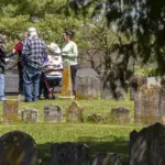 The Sullivan family meets at the Jerusalem Lutheran Church cemetery after researching their family roots.